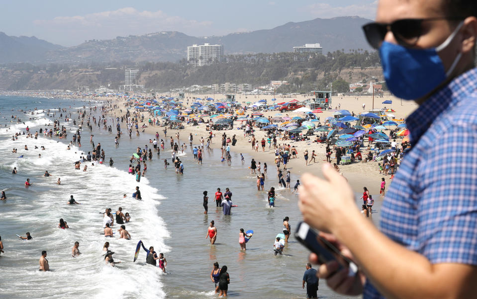 People gather on the beach at the Pacific Ocean on the first day of the Labor Day weekend amid a heatwave on September 5, 2020 in Santa Monica, California. Temperatures are soaring across California sparking concerns that crowded beaches could allow for wider spread of the coronavirus amid the COVID-19 pandemic. / Credit: Mario Tama  / Getty Images