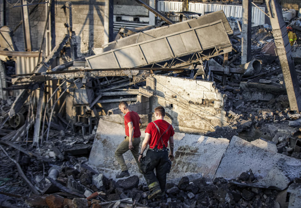 Firefighters walk amid the debris of a metal factory destroyed by an explosion, in Cabreuva, Brazil, Friday, Sept. 1, 2023. The explosion in southern Brazil killed several people and seriously injured at least a dozen others, state officials said. (AP Photo/Tuane Fernandes)