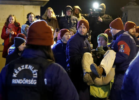 Police officers detain a demonstrator during a protest against a proposed new labor law, billed as the "slave law", in Budapest, Hungary, January 19, 2019. REUTERS/Bernadett Szabo