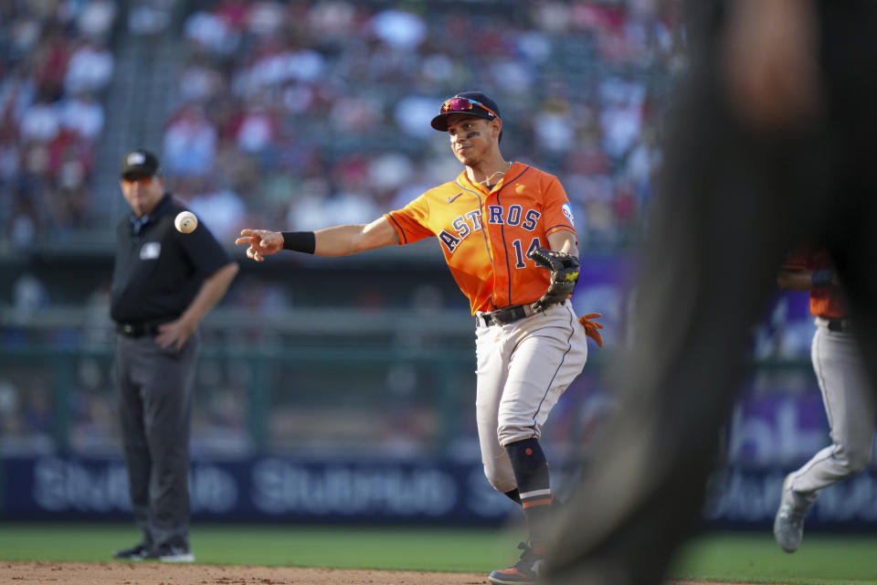 Houston Astros second baseman Mauricio Dubon (14) throws to first base during the sixth inning of a baseball game against the Los Angeles Angels in Anaheim, Calif., Sunday, July 16, 2023. (AP Photo/Eric Thayer)