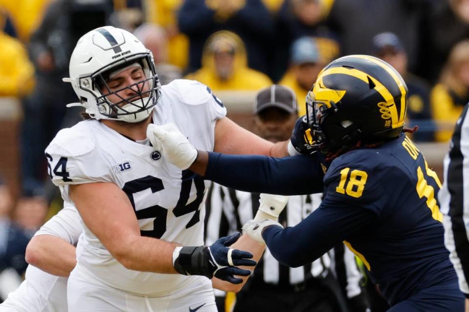 Penn State Nittany Lions offensive lineman Hunter Nourzad (64) blocks Michigan Wolverines linebacker Eyabi Okie (18) in the second half at Michigan Stadium on Oct. 15, 2022.