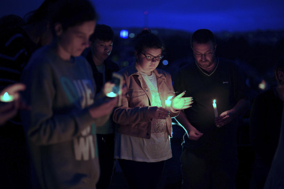 People attend a vigil for the victims of the mass shooting in Plymouth, England, Friday Aug. 13, 2021. Six people, including the offender, his own mother and a three-year old girl and her father, died of gunshot wounds in a firearms incident on Thursday evening. (Ben Birchall/PA via AP)