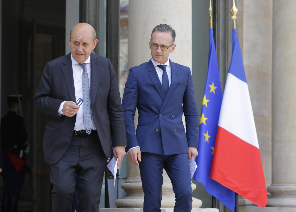 French Foreign Minister Jean-Yves Le Drian, left, and his German counterpart Heiko Maas arrives for a media conference after the cabinet meeting at the Elysee Palace in Paris, France, Wednesday, June 19, 2019. German Foreign Minister Heiko Maas says the risk of war in the Gulf is not ruled out amid rising tensions between Iran and the United States.(AP Photo/Michel Euler)