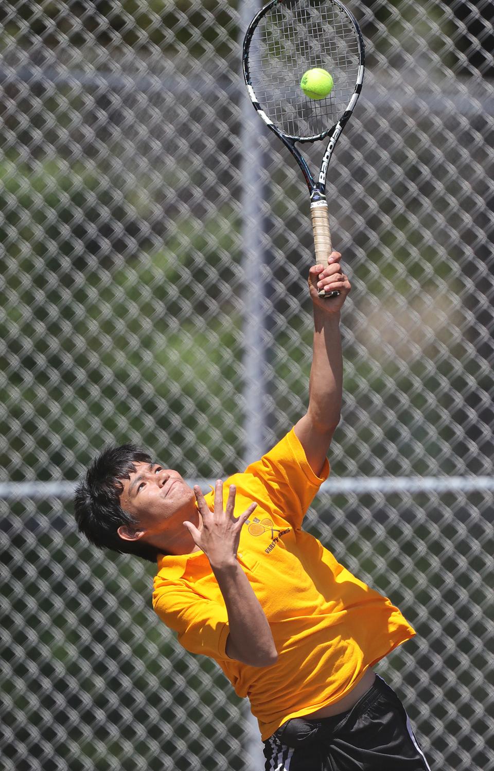 North's Sanjil Magar serves to Firestone's Reece Caraboolad in the City Series Tennis Tournament on Monday, May 9, 2022 in Akron, Ohio, at Hyre Park.