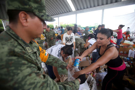 Soldiers and people organise donated aid at a shelter set up by the army after an earthquake, in Jojutla de Juarez, Mexico September 21, 2017. REUTERS/Edgard Garrido