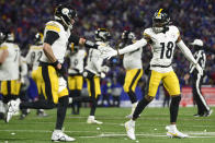 Pittsburgh Steelers wide receiver Diontae Johnson (18) celebrates with quarterback Mason Rudolph (2) after scoring a touchdown during the second quarter of an NFL wild-card playoff football game, Monday, Jan. 15, 2024, in Buffalo, N.Y. (AP Photo/Adrian Kraus)