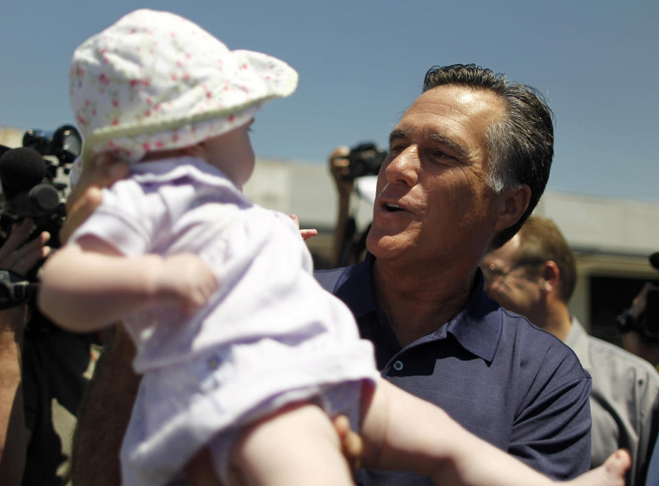 U.S. Republican presidential candidate and former Massachusetts Governor Mitt Romney lifts up 7-month-old baby Sarah Winnick during a campaign stop in Los Angeles, California July 20, 2011. REUTERS/Lucy Nicholson