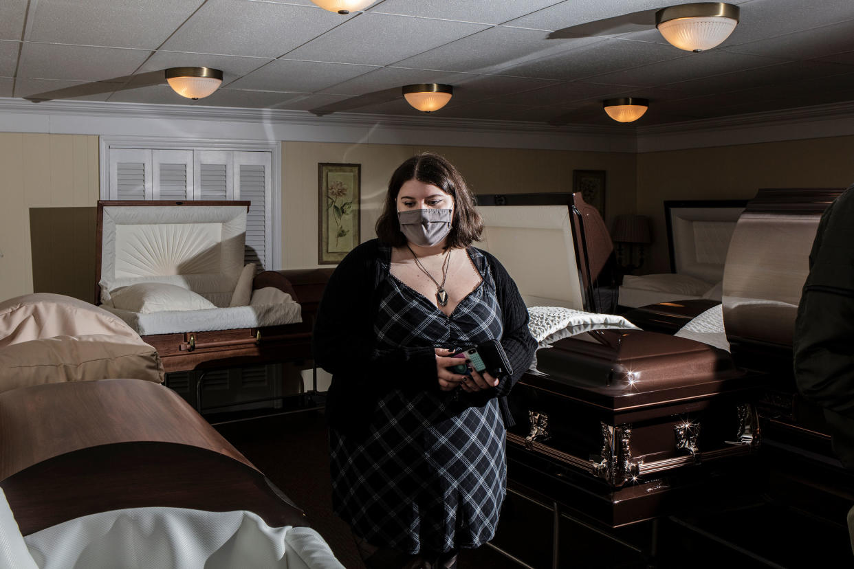 A student examines a casket during a Kean University course on death at Galante Funeral Home in Union, N.J., on Wednesday, February 2, 2022.CREDIT: Bryan Anselm/Redux for TIME