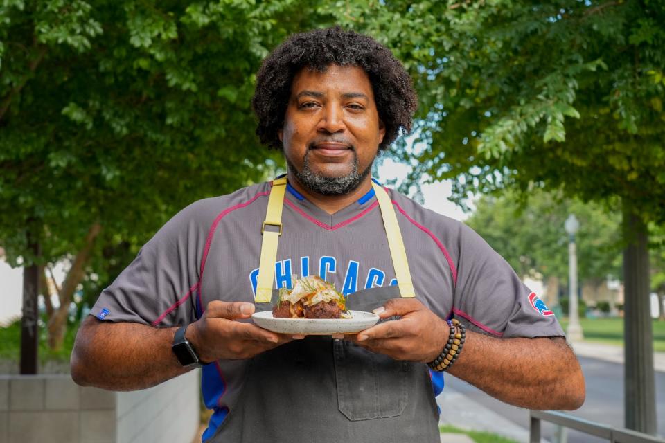 The Larder + The Delta Chef Stephen Jones holds a plate of hush puppies in Phoenix on June 9, 2022.