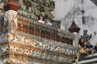 Chinese tourists take selfies at Wat Arun or the "Temple of Dawn" in Bangkok, Thailand on Jan. 12, 2023. A hoped-for boom in Chinese tourism in Asia over next week’s Lunar New Year holidays looks set to be more of a blip as most travelers opt to stay inside China if they go anywhere. (AP Photo/Sakchai Lalit)