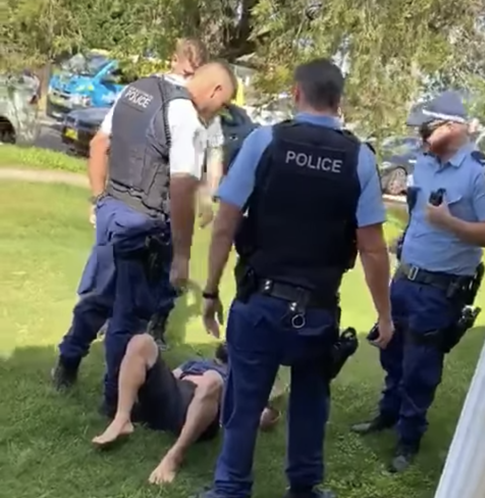 It took four police to wrestle this man to the front lawn. Source: Facebook/SCN Sydney Crime News