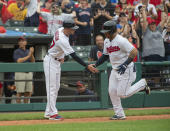 Cleveland Indians' Harold Ramirez, right, is greeted by third base coach Kyle Hudson after hitting a solo home run off Chicago White Sox relief pitcher Craig Kimbrel during the eighth inning of a baseball game in Cleveland, Sunday, Sept. 26, 2021. (AP Photo/Phil Long)