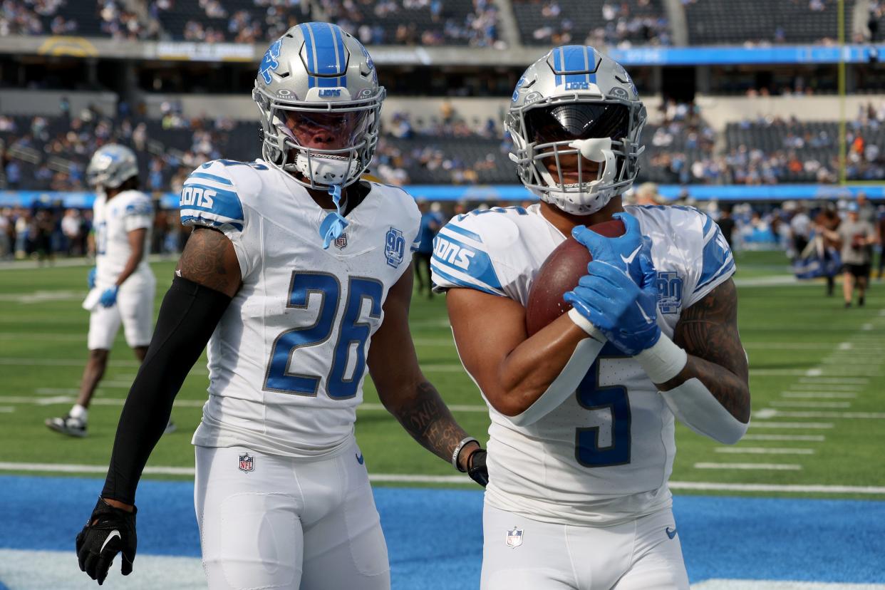 Lions running backs David Montgomery, right, and Jahmyr Gibbs warm up before the game against the Los Angeles Chargers on Sunday, Nov. 12, 2023, in Inglewood, California.