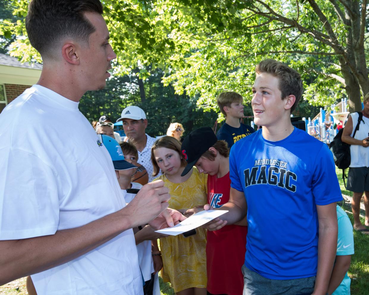 Miami Heat player Duncan Robinson signs an autograph for AJ Reinertson of York Maine, during the dedication of Duncan Robinson Court at Maude H. Trefethen School in New Castle Thursday, Aug. 26, 2021. Reinertson currently plays for the Middlesex Magic, the same AAU team Robinson played for as a youth.