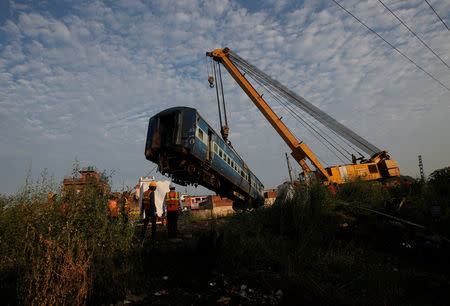 A damaged coach of a passenger train is removed from the site of an accident in Khatauli, in the northern state of Uttar Pradesh, India August 20, 2017. REUTERS/Adnan Abidi