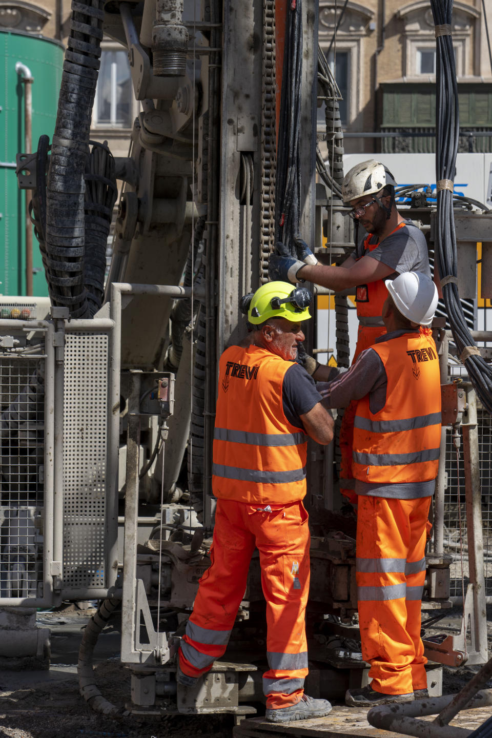 Workers inject reactive chemicals to consolidate the construction site of the new 25.5-kilometer Metro C subway main hub in Piazza Venezia in central Rome, Thursday, May 23, 2024. During a tour Thursday of the construction site at Piazza Venezia, chief engineer Andrea Sciotti said works on the nearly 3 billion euro project, considered one of the most complicated in the world, were running at pace to be completed by 2034. In the background the Unknown Soldier monument. (AP Photo/Domenico Stinellis)