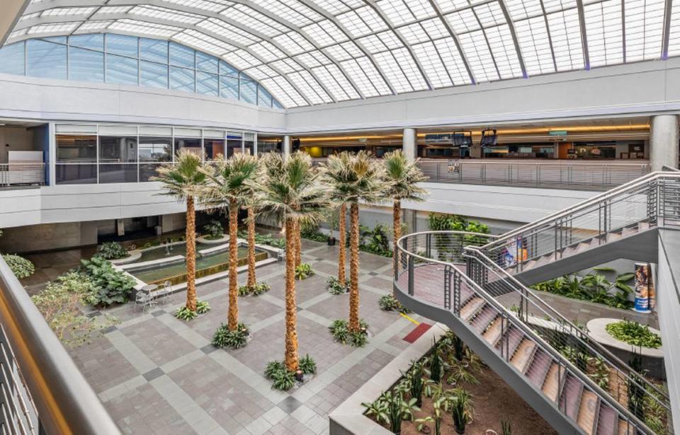 The new headquarters includes palm trees and a water fountain in the middle of its main interior courtyard, shown here in center and center left.