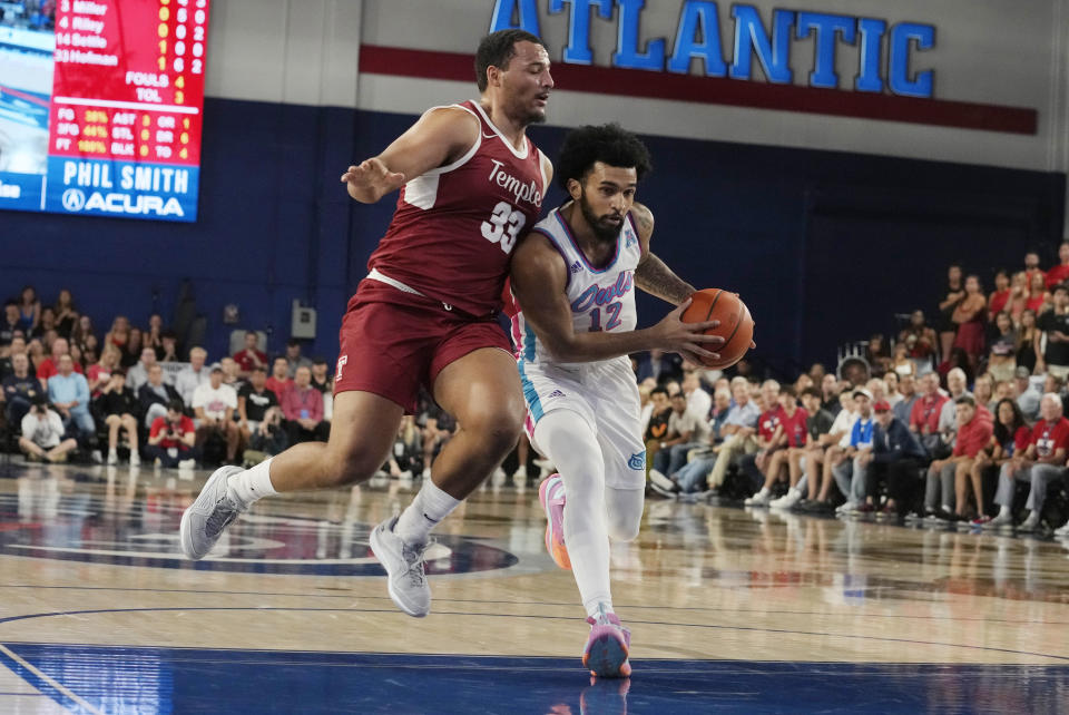 Temple forward Sam Hofman (33) fouls Florida Atlantic guard Jalen Gaffney (12) during the first half of an NCAA college basketball game, Thursday, Feb. 15, 2024, in Boca Raton, Fla. (AP Photo/Marta Lavandier)