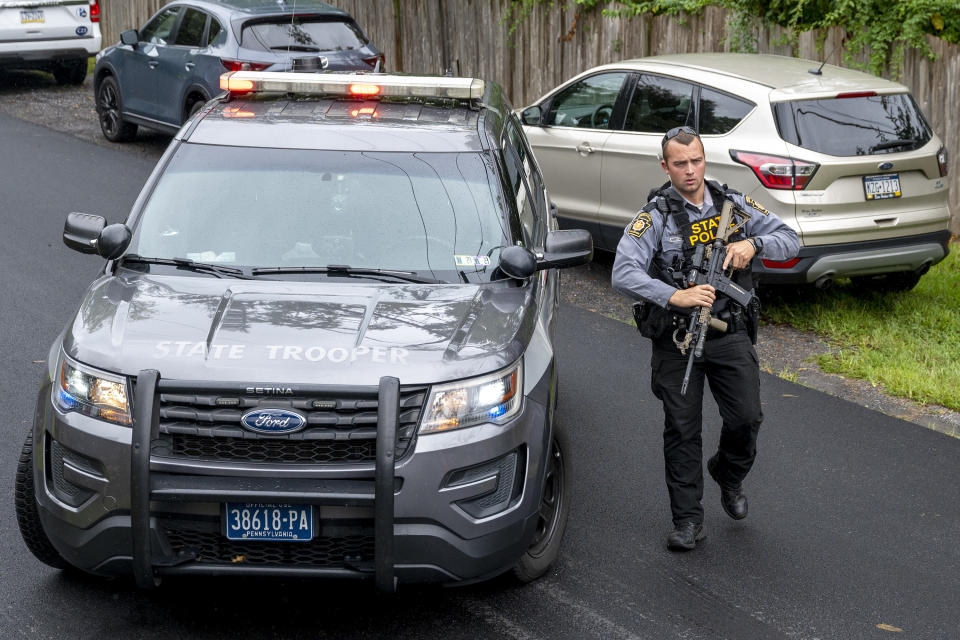 Pennsylvania State Troopers and other law enforcement officers are on the scene in Nantmeal Village as the search for escaped convict Danelo Cavalcante moved to northern Chester County, Sunday, Sept. 10, 2023. (Tom Gralish/The Philadelphia Inquirer via AP)