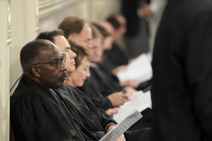 South Carolina Supreme Court Chief Justice Don Beatty, left, sits with other justices during Gov. Henry McMaster's State of the State address on Wednesday, Jan. 25, 2023, in Columbia, S.C. (AP Photo/Meg Kinnard)