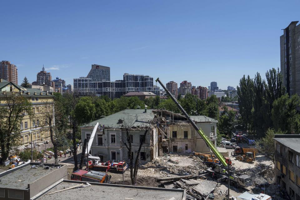 Rescue workers clear the rubble at the site of Okhmatdyt children's hospital hit by Russian missiles on Monday, in Kyiv, Ukraine, Tuesday, July 9, 2024. (AP Photo/Evgeniy Maloletka)