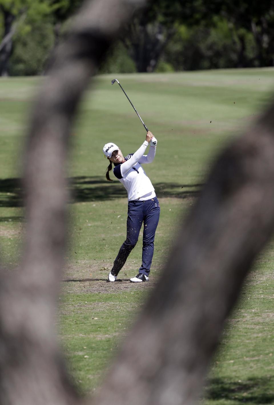 Meena Lee, of South Korea, watches her approach shot to the first green during the second round of the North Texas LPGA Shootout golf tournament at the Las Colinas Country Club in Irving, Texas, Friday, May 2, 2014. (AP Photo/LM Otero)