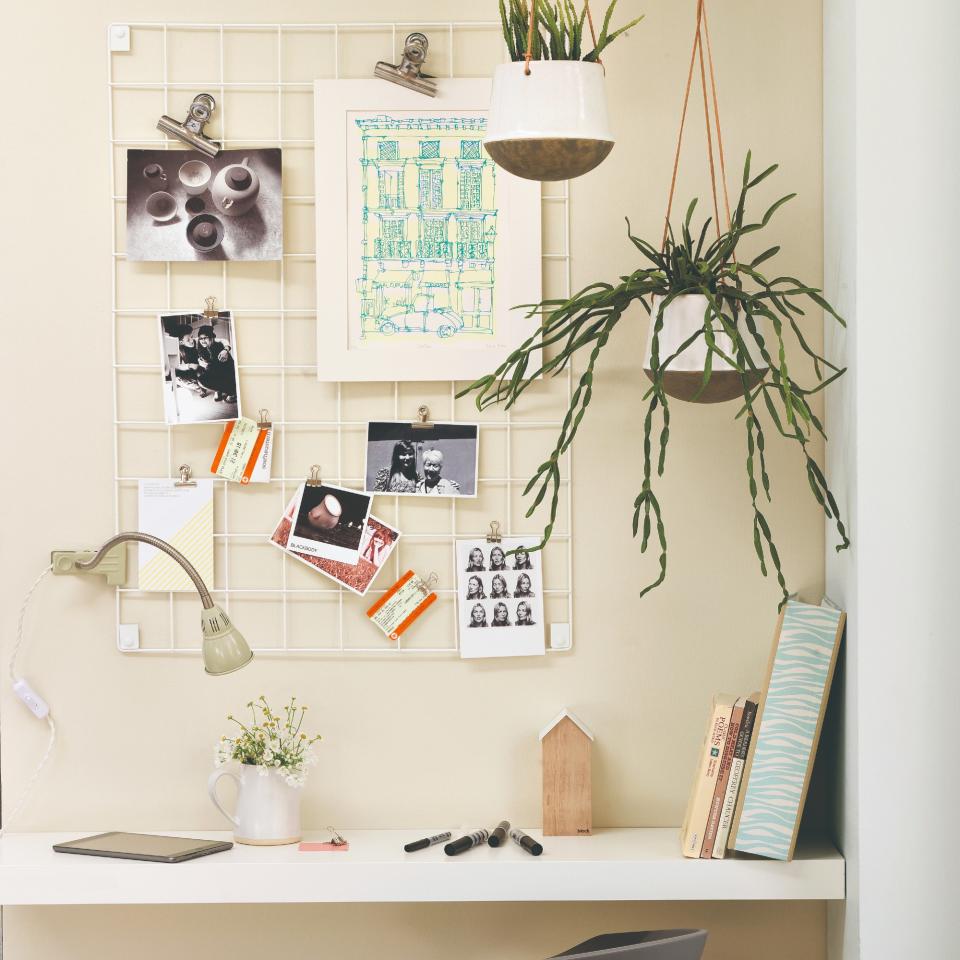 A home office with a board with artworks