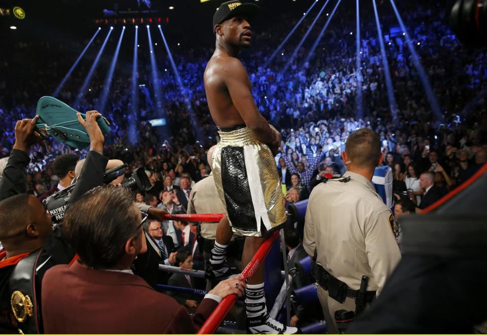 Floyd Mayweather, Jr. of the U.S. stands up on the ropes in his corner after defeating Manny Pacquiao of the Philippines in their welterweight WBO, WBC and WBA (Super) title fight in Las Vegas, Nevada, May 2, 2015. REUTERS/Steve Marcus