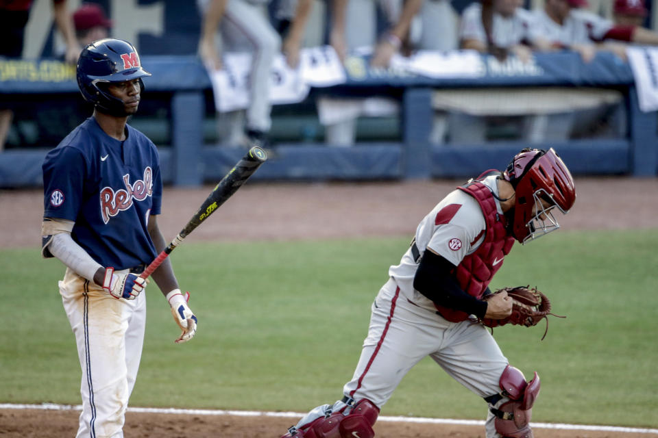 Arkansas catcher Casey Opitz celebrates as Mississippi's TJ McCants (16) reacts to striking out in the ninth inning of an NCAA college baseball game during the Southeastern Conference tournament Saturday, May 29, 2021, in Hoover, Ala. Arkansas won 3-2 to advance to the championship game. (AP Photo/Butch Dill)