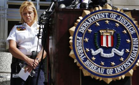Metropolitan Police Chief Cathy Lanier pauses as she listens to Assistant Director in Charge of the FBI's Washington Field Office Valerie Parlave (not seen) host a news conference to share the findings about the investigation into the shootings at the Navy Yard last Monday at the FBI's Washington Field Office in Washington, September 25, 2013. REUTERS/Larry Downing