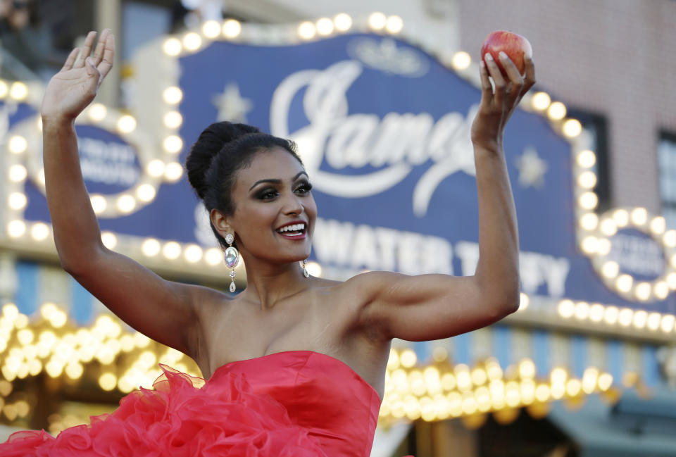 Miss New York Nina Davuluri smiles for the crowd during the Miss America Shoe Parade at the Atlantic City boardwalk, Saturday, Sept. 14, 2013, in Atlantic City, N.J. (AP Photo/Julio Cortez)