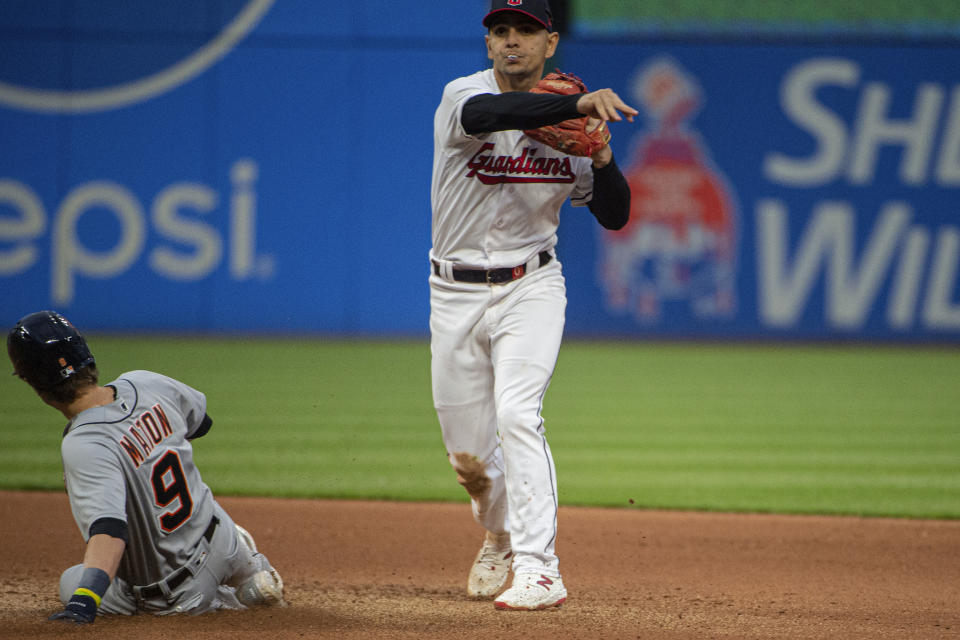 Cleveland Guardians' Andres Gimenez, right, forces out Detroit Tigers' Nick Maton (9) at second base and throws to first base to get Tigers' Spencer Torkelson for a double play during the seventh inning of a baseball game in Cleveland, Monday, May 8, 2023. (AP Photo/Phil Long)