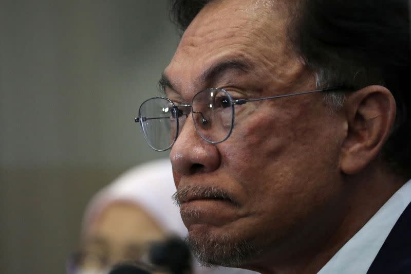 Malaysia opposition leader Anwar Ibrahim reacts during a news conference in Kuala Lumpur