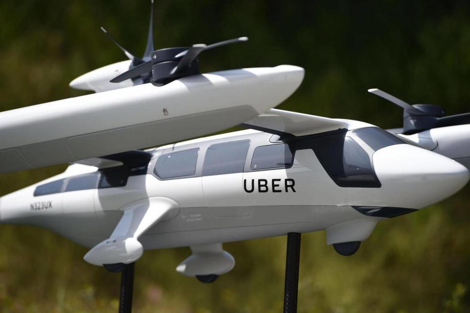 A model of Uber's electric vertical take-off and landing vehicle concept (eVTOL) flying taxi is displayed at the second annual Uber Elevate Summit, on May 8, 2018 at the Skirball Center in Los Angeles, California. Uber introduced it's electric powered 'flying taxi' vertical take-off and landing concept aircraft at the event, which showcases prototypes for UberAir's fleet of airborne taxis. (Getty Images)