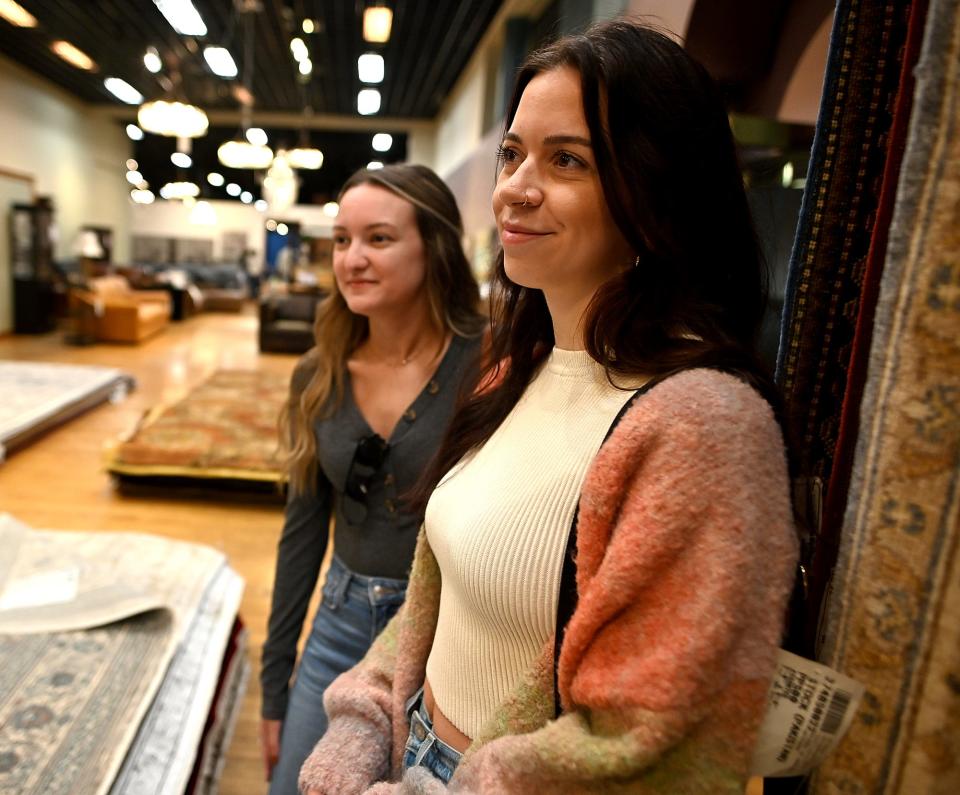 Amanda Woodward and Alexis Lusignan, both of Worcester, shop Saturday at Rotmans during the longtime Southbridge Street furniture store's going-out-of-business liquidation sale.