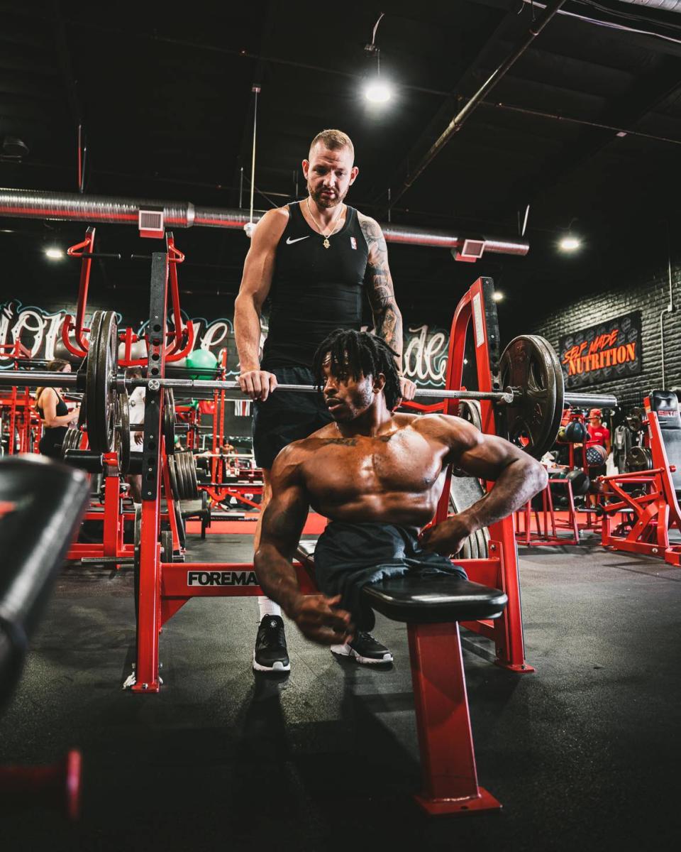 Zion Clark, formerly of Massillon, is shown on the bench press while Craig Levinson spots him. Born without legs, Clark is a mixed martial arts fighter and former college wrestler.