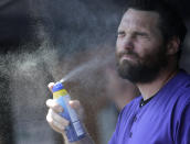 Colorado Rockies' Daniel Murphy applies sunscreen before a baseball game against the New York Yankees at Yankee Stadium, Sunday, July 21, 2019, in New York. (AP Photo/Seth Wenig)