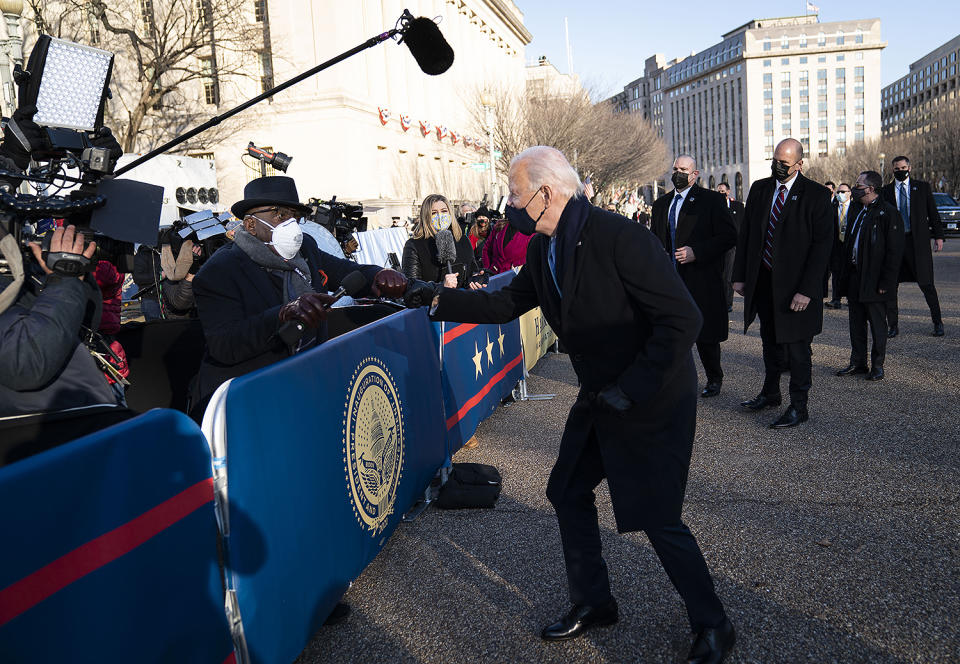 <p>President Biden jogs over to <em>Today</em> anchor Al Roker to give him a friendly fist bump during the parade. </p>