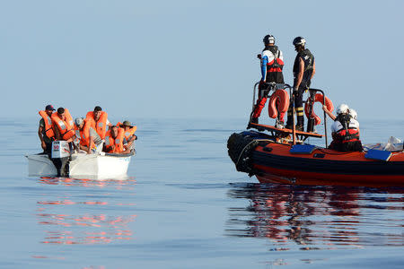 Migrants are seen on board a fiberglass boat in the Mediterranean Sea, off the Libyan Coast, August 12, 2018. Picture taken August 12, 2018. REUTERS/Guglielmo Mangiapane