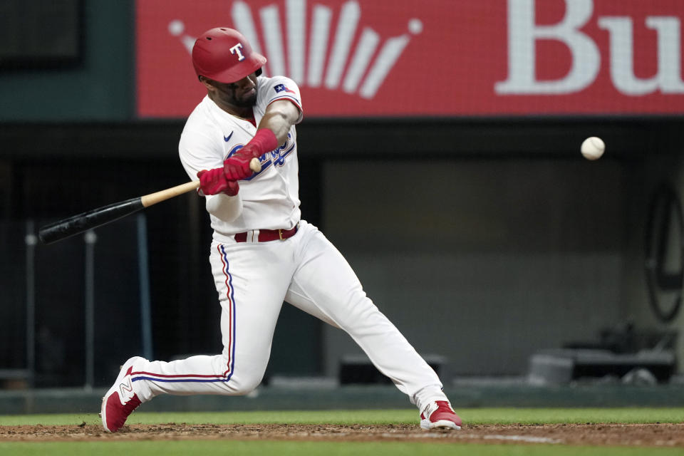 Texas Rangers' Ezequiel Duran turns to hit a solo home run during the fifth inning of a baseball game against the Colorado Rockies in Arlington, Texas, Saturday, May 20, 2023. (AP Photo/LM Otero)