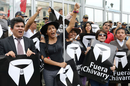 People hold placards reading "Chavarry out" referring to Peru Attorney General Pedro Chavarry, during a protest outside the Attorney General's Office in Lima, Peru, January 8, 2019. REUTERS/Mariana Bazo