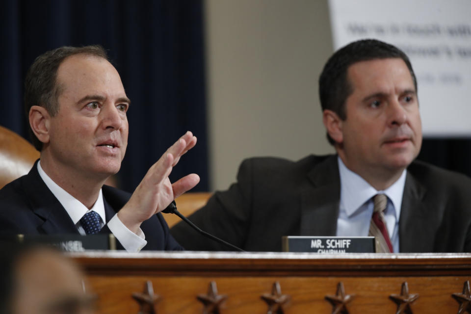 House Intelligence Committee Chairman Adam Schiff, D-Calif., left, and ranking member Rep. Devin Nunes, R-Calif., right, talk to Jennifer Williams, an aide to Vice President Mike Pence, and National Security Council aide Lt. Col. Alexander Vindman, during testimony before the House Intelligence Committee on Capitol Hill in Washington, Tuesday, Nov. 19, 2019, during a public impeachment hearing of President Donald Trump's efforts to tie U.S. aid for Ukraine to investigations of his political opponents. (AP Photo/Alex Brandon)