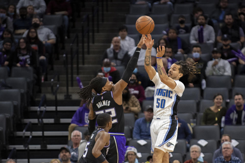 Orlando Magic guard Cole Anthony (50) has his shot blocked by Sacramento Kings center Richaun Holmes (22) during the first quarter of an NBA basketball game in Sacramento, Calif., Wednesday, Dec. 8, 2021. (AP Photo/Jose Luis villegas)