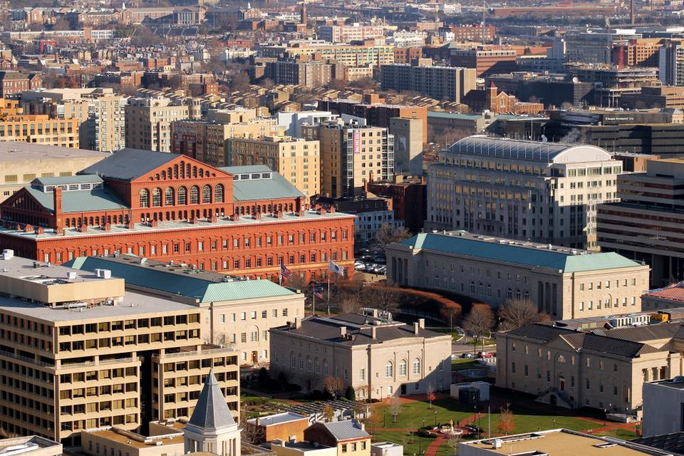 The National Building Museum (seen in red brick) is an important example of Renaissance Revival architecture.