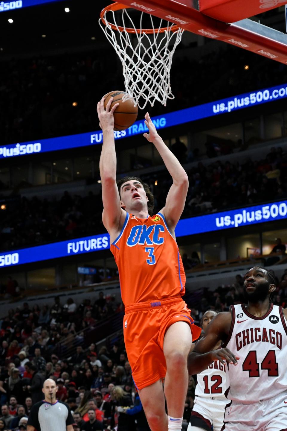 Oklahoma City Thunder guard Josh Giddey (3) scores past Chicago Bulls forward Patrick Williams (44) during the first half of an NBA basketball game Friday, Jan. 13, 2023, in Chicago. (AP Photo/Matt Marton)