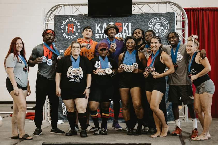 Powerlifters from The House of Gains participate in a competition.