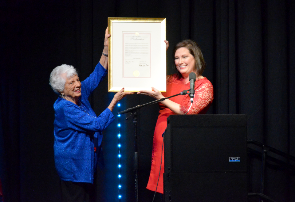 Jen Schroer, cabinet secretary of the New Mexico Department of Tourism, presents Barbara "Mother" Hubbard with a governor's proclamation recognizing Barbara Hubbard Day at "95 and Very Much Alive: A Special Tribute to Barbara Hubbard" Wednesday, Oct. 19, 2022 at the Pan American Center.