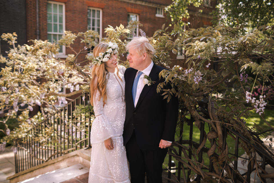 LONDON, UNITED KINGDOM - MAY 29:  In this handout image released by 10 Downing Street, Prime Minister Boris Johnson poses with his wife Carrie Johnson in the garden of 10 Downing Street following their wedding at Westminster Cathedral, May 29, 2021 in London, England. The secretly planned wedding took place in a small ceremony on Saturday afternoon. Johnson is the first Prime Minister to get married while in office in nearly 200 years. (Photo by Rebecca Fulton / Downing Street via Getty Images)