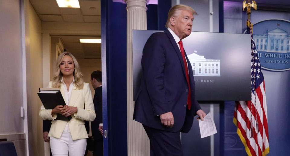 Kayleigh McEnany and Donald Trump shown walking into a press briefing. Source: Getty