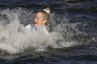 Nelly Korda jumps into the lake after winning the Chevron Championship LPGA golf tournament Sunday, April 21, 2024, at The Club at Carlton Woods in The Woodlands, Texas. (AP Photo/David J. Phillip)